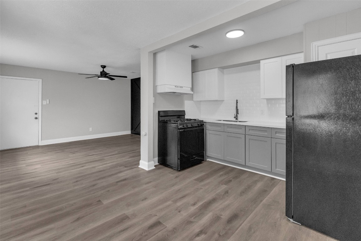 3613 Crane Street Houston, TX 77026 - Photo 6 of 23 a kitchen with stainless steel appliances a refrigerator sink and cabinets