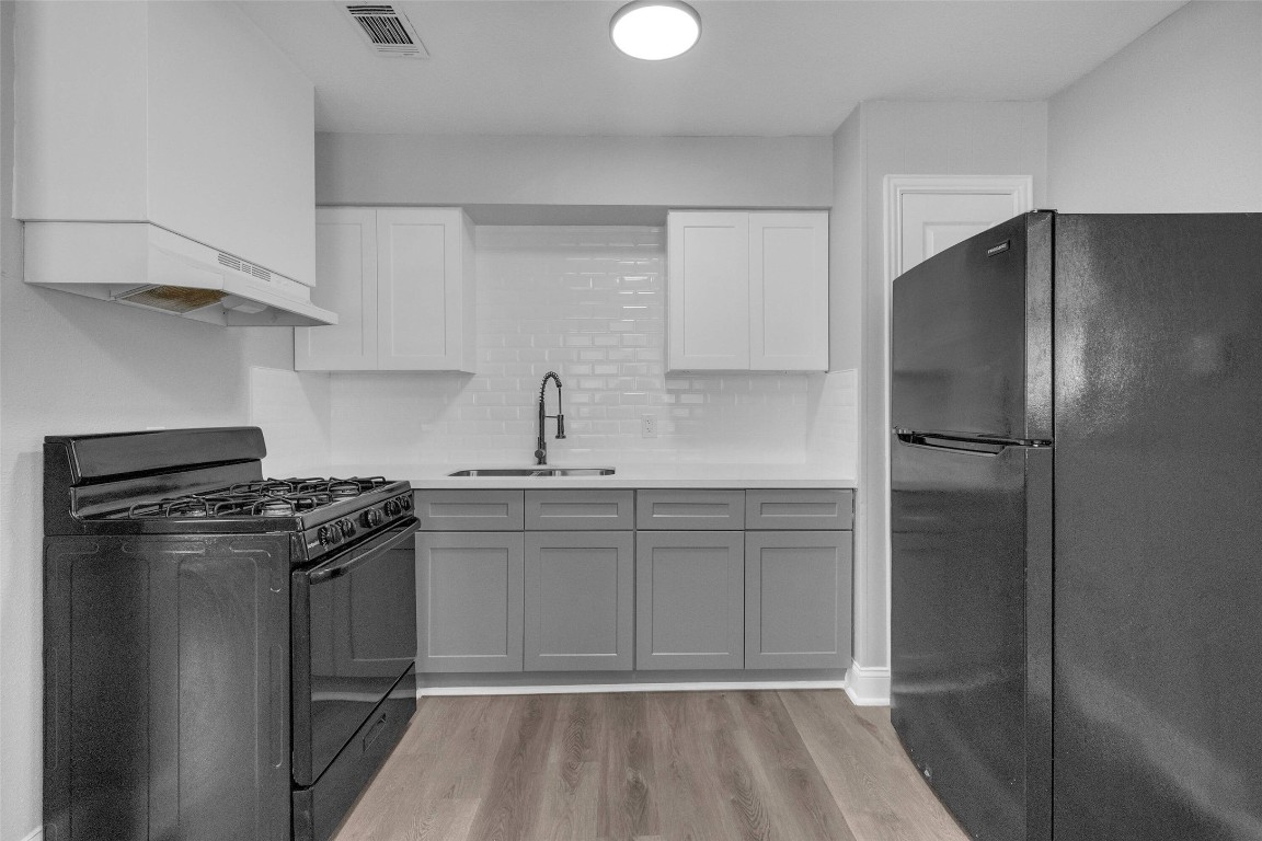 3613 Crane Street Houston, TX 77026 - Photo 7 of 23 a kitchen with a stove sink and refrigerator