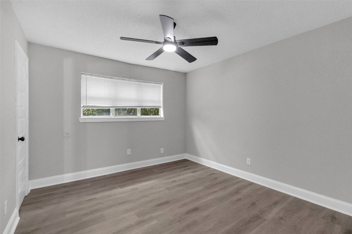 3613 Crane Street Houston, TX 77026 - Photo 10 of 23 an empty room with wooden floor ceiling fan and windows
