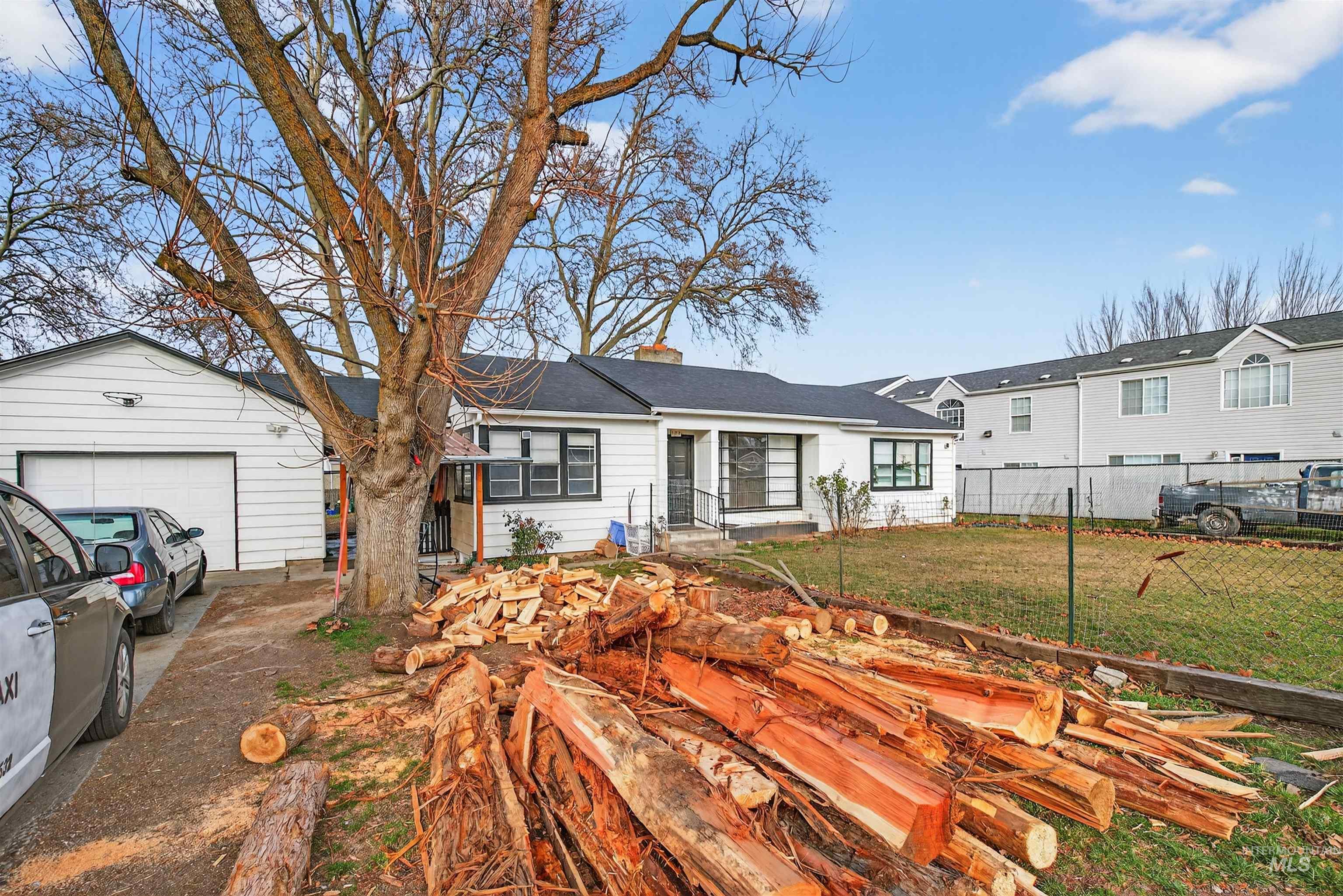 Ranch-style house featuring a chimney, a garage, and concrete driveway