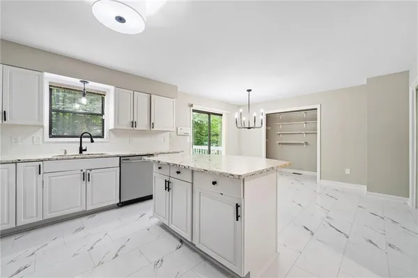 a kitchen with sink cabinets and window