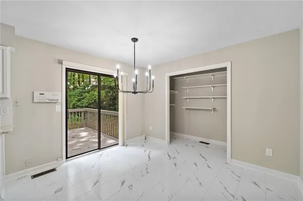 a view of empty room with floor to ceiling window