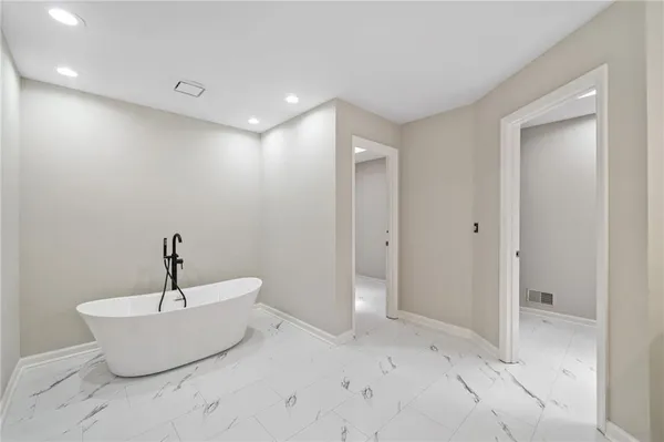 a bathroom with a bathtub and shower