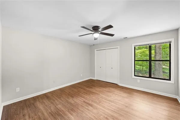 wooden floor in an empty room with a window