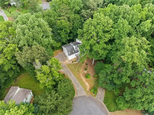 an aerial view of a house with a yard