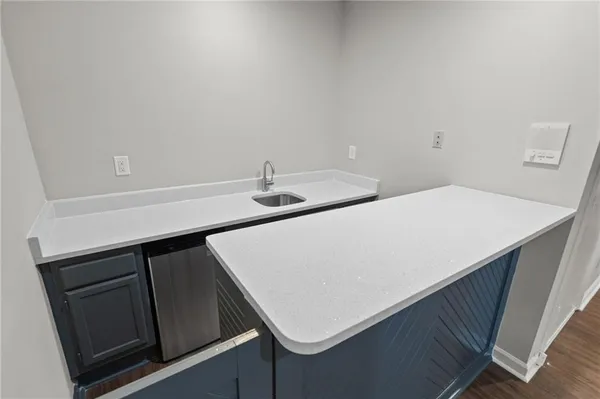 a kitchen with a sink and cabinets