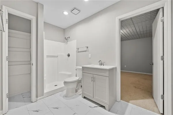 a bathroom with a toilet sink and shower