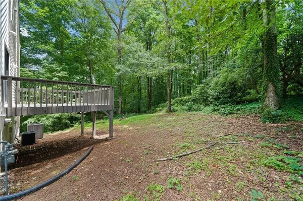 a view of a backyard with a wooden fence