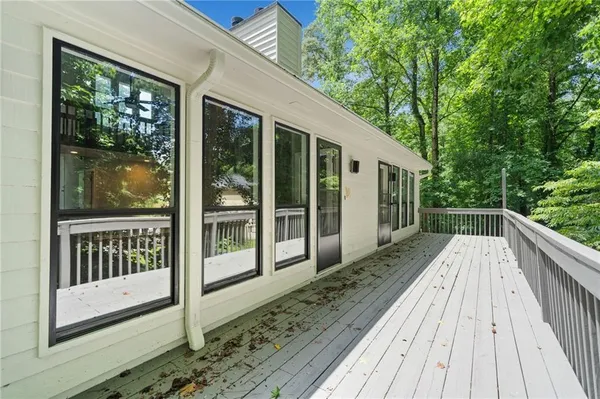 a view of balcony with wooden floor and fence