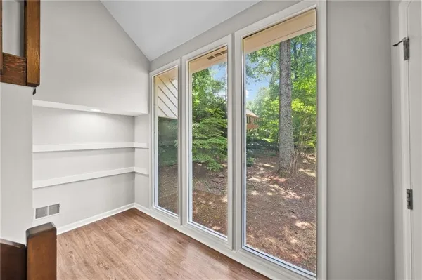 a view of a room with wooden floor and balcony
