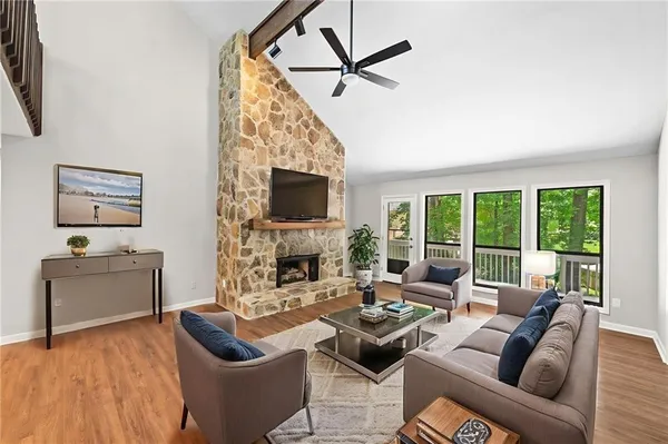 a living room with furniture a fireplace and a flat screen tv