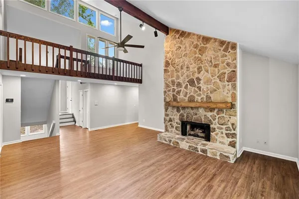 an entryway with a fireplace and wooden floor