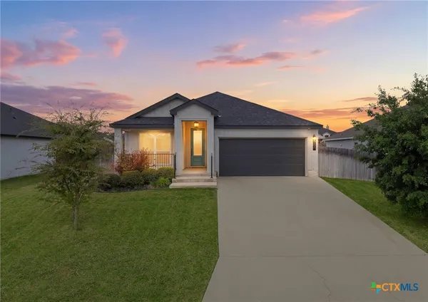 a front view of a house with a garden