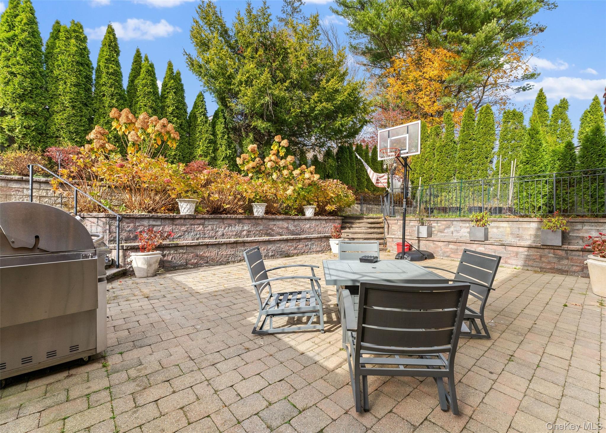 6 Hunting Ridge Road White Plains, NY 10605 - Photo 26 of 32 a view of a patio with a table and chairs and potted plants