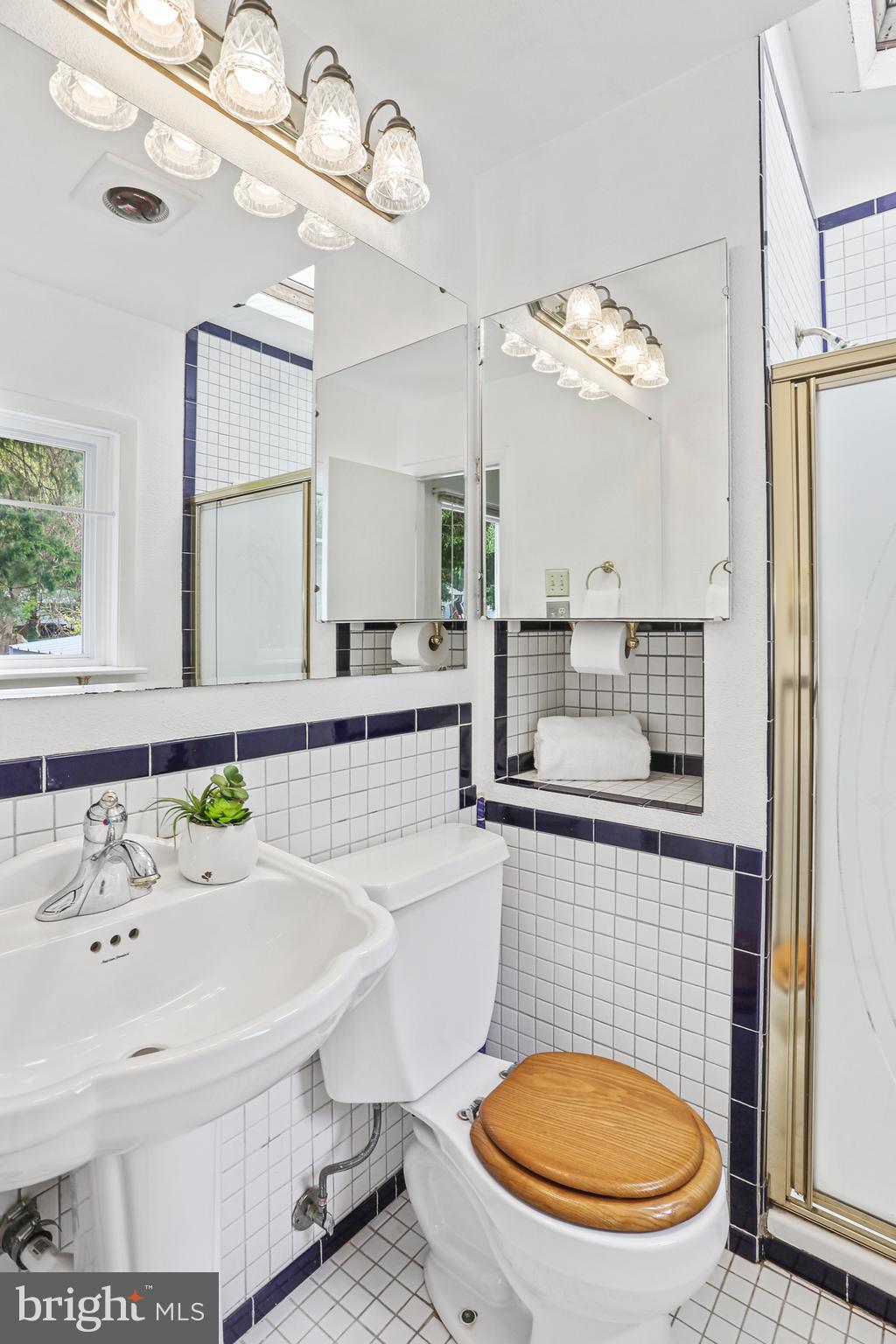 3035 Tarpon Road Riva, MD 21140 - Photo 21 of 31 a bathroom with a sink a toilet a mirror and shower