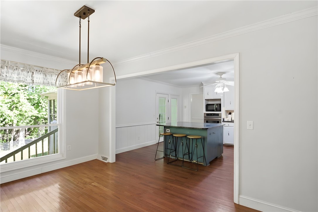 311 Cumberland Way Anderson, SC 29621 - Photo 9 of 44 Hardwood floors and a stylish chandelier define this bright dining area, perfect for entertaining.