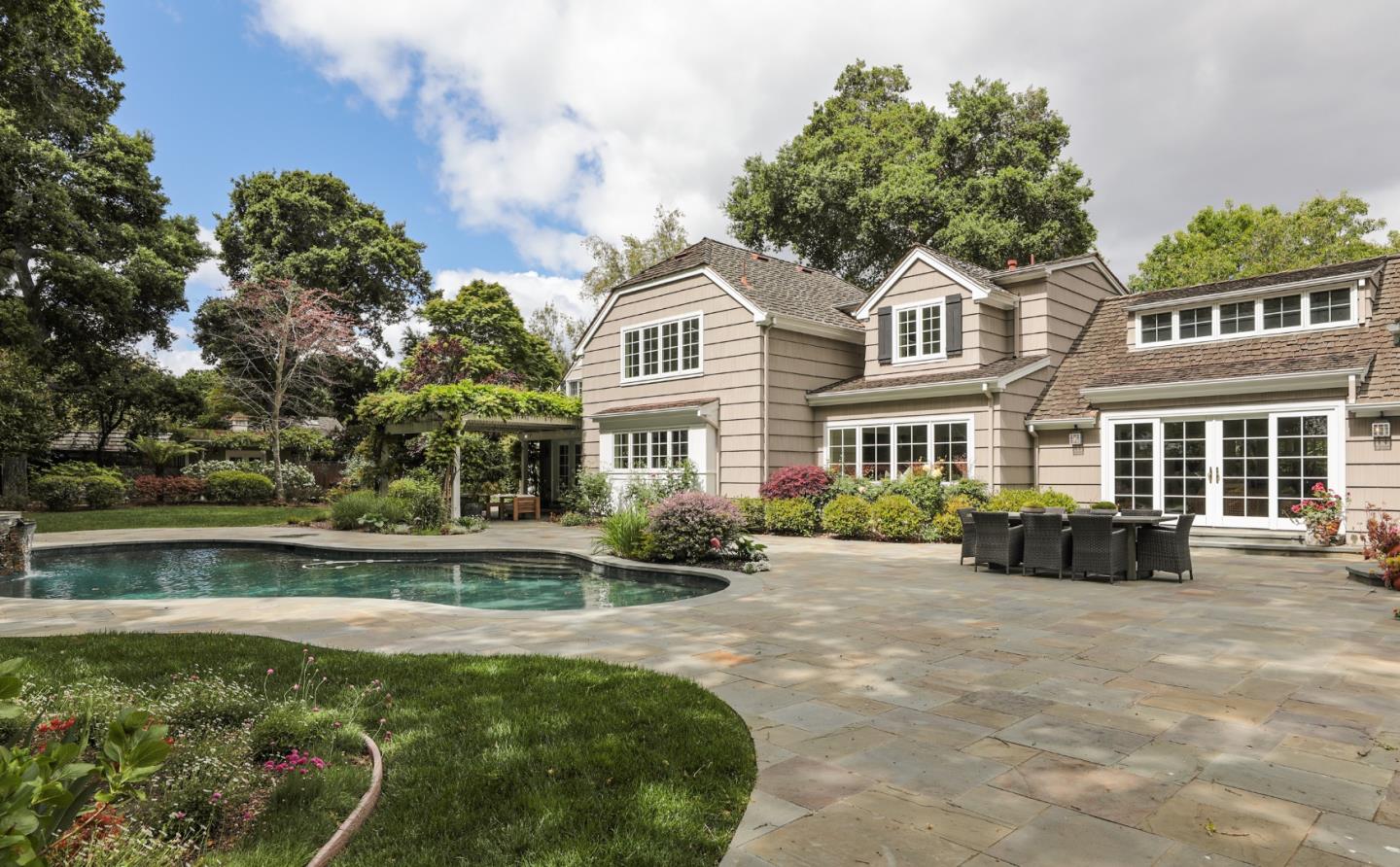 a front view of a house with swimming pool having outdoor seating