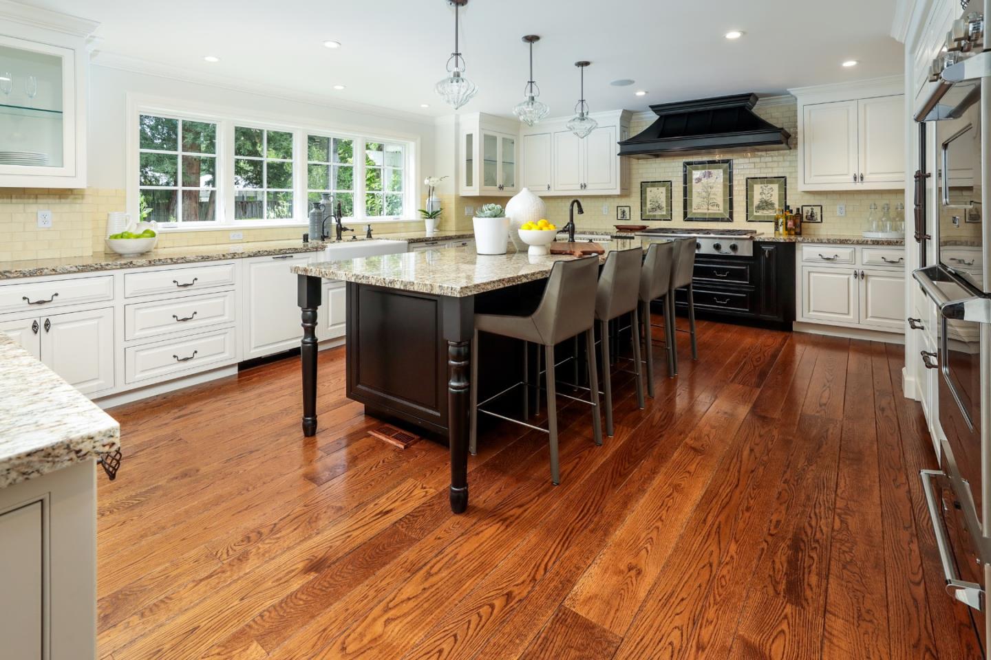 96 Laburnum Road Atherton, CA 94027 - Photo 15 of 40 a kitchen with stainless steel appliances granite countertop wooden floors stove top oven and cabinets