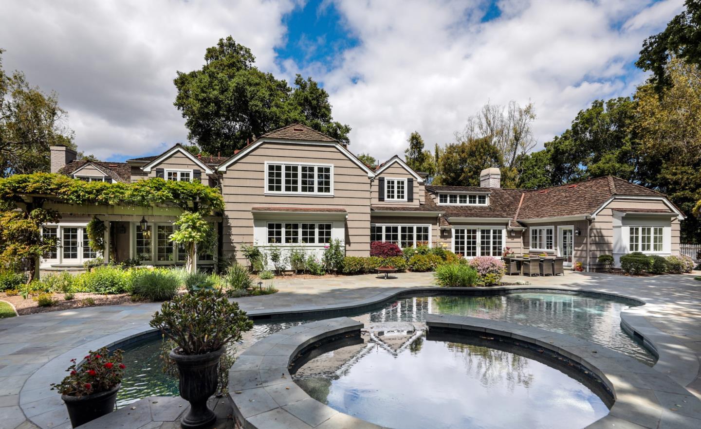 96 Laburnum Road Atherton, CA 94027 - Photo 6 of 40 a view of a white house with a swimming pool and a yard