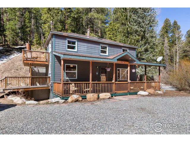 a view of a house with a backyard and porch