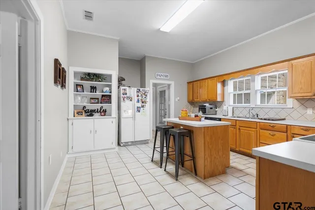 a kitchen with stainless steel appliances granite countertop a refrigerator and a sink