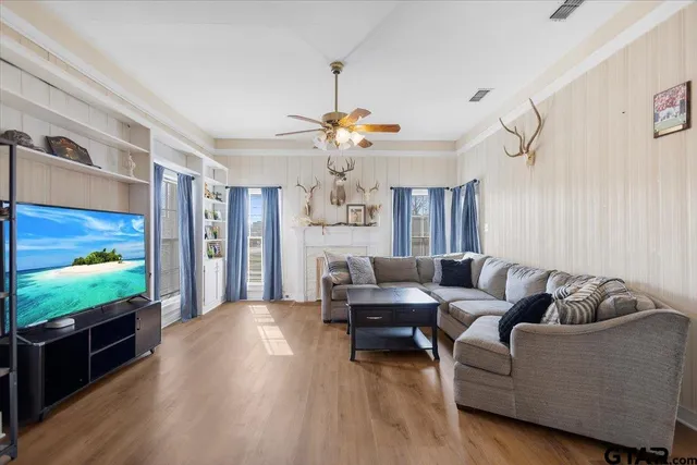 a living room with furniture and a flat screen tv
