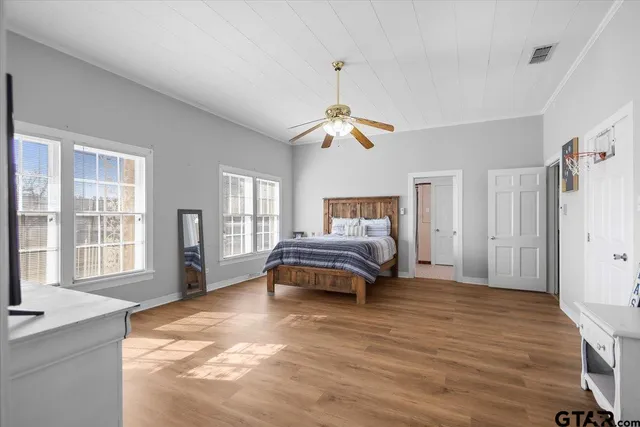 a bedroom with a bed and a chandelier