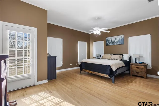 a bedroom with a large bed and a chandelier