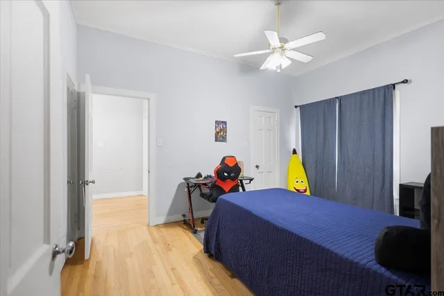 a view of a bedroom with a bed and a chandelier