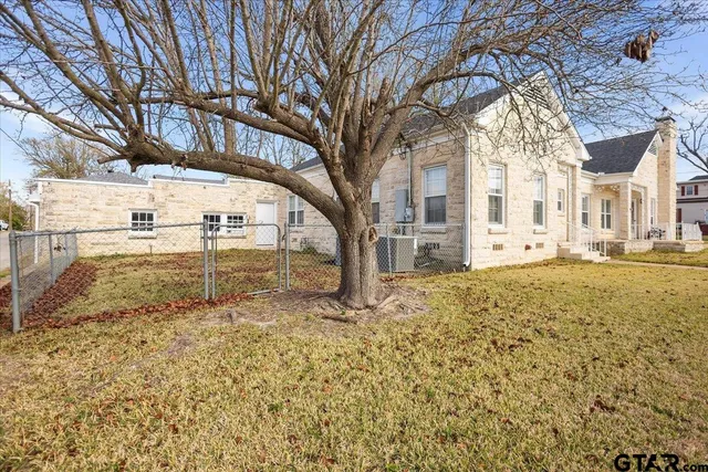 a view of a yard with large trees