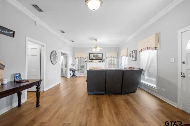 a living room with furniture and a wooden floor