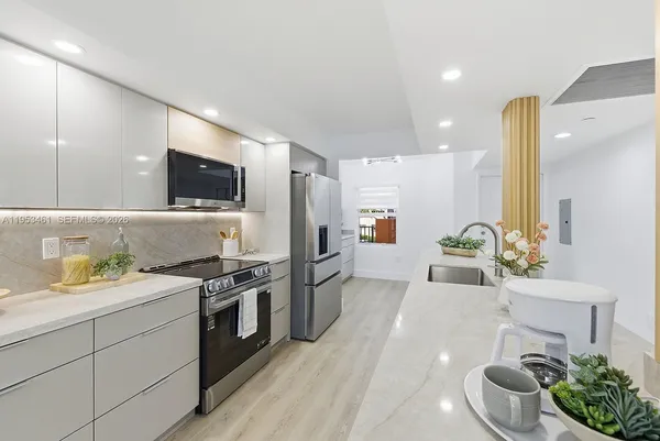 a kitchen with a sink stove and refrigerator