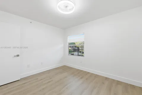an empty room with wooden floor