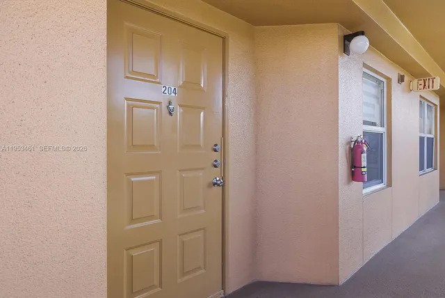 a view of sign board with flower plants