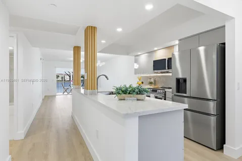 a kitchen with refrigerator and sink
