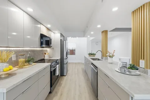 a large kitchen with stainless steel appliances a lot of counter space