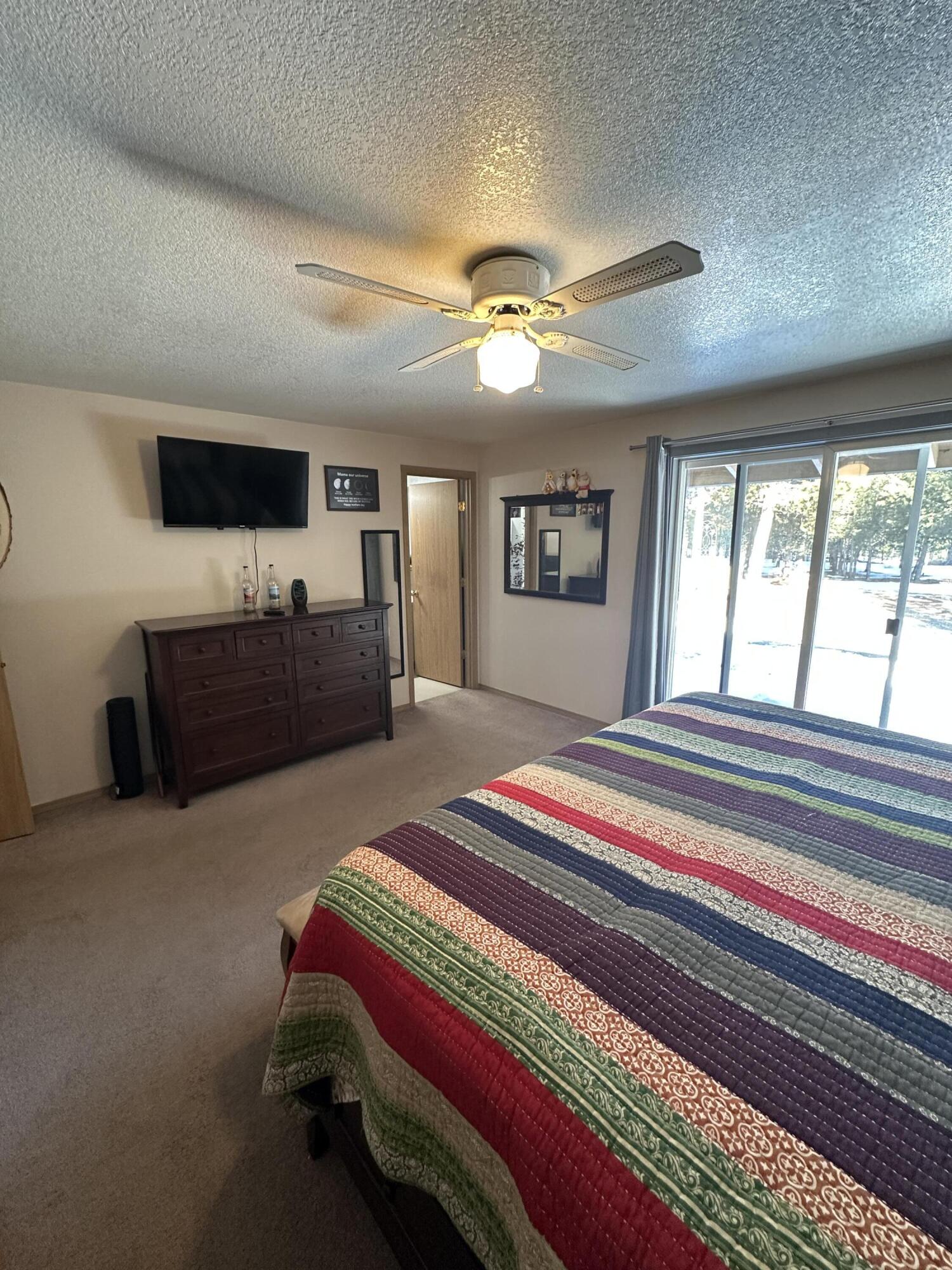 123977 Surveyor Road Crescent Lake, OR 97733 - Photo 36 of 41 a bedroom with a bed dresser and a window