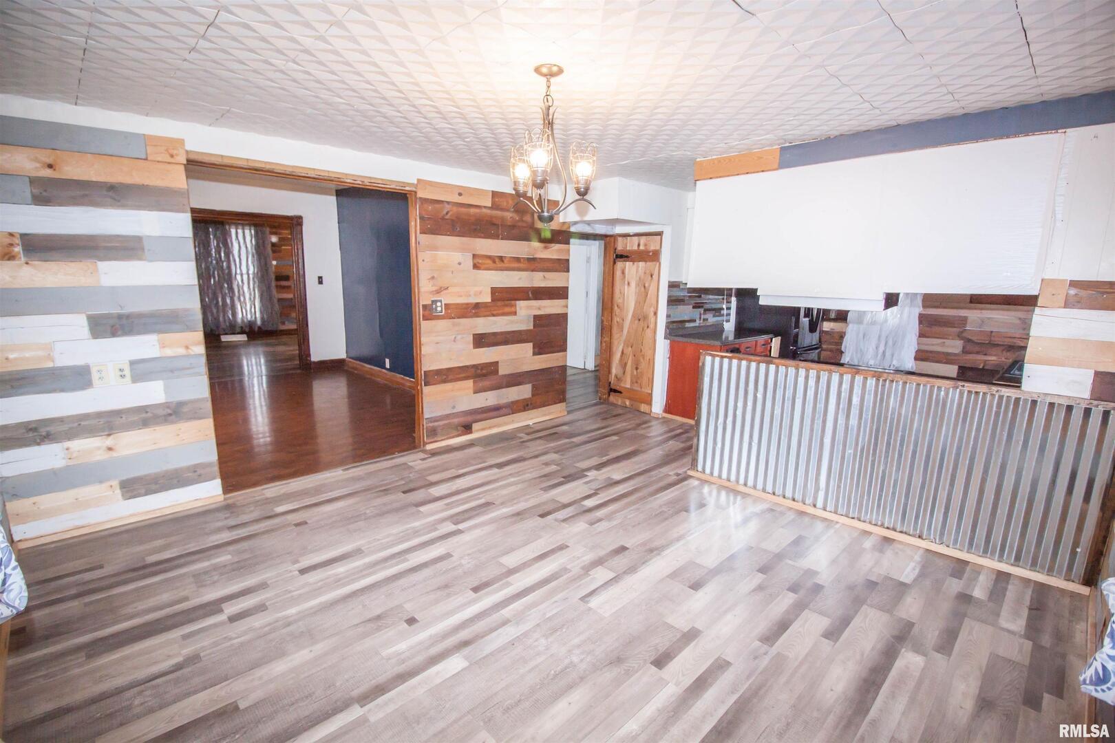 201 North 1st Street Alpha, IL 61413 - Photo 15 of 28 a view of a livingroom with a furniture wooden floor and chandelier