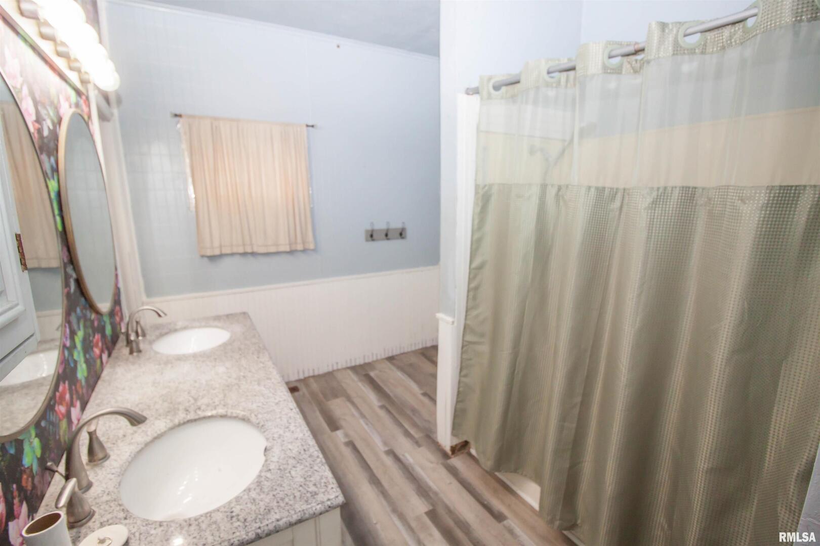 201 North 1st Street Alpha, IL 61413 - Photo 18 of 28 a bathroom with a granite countertop sink and a mirror