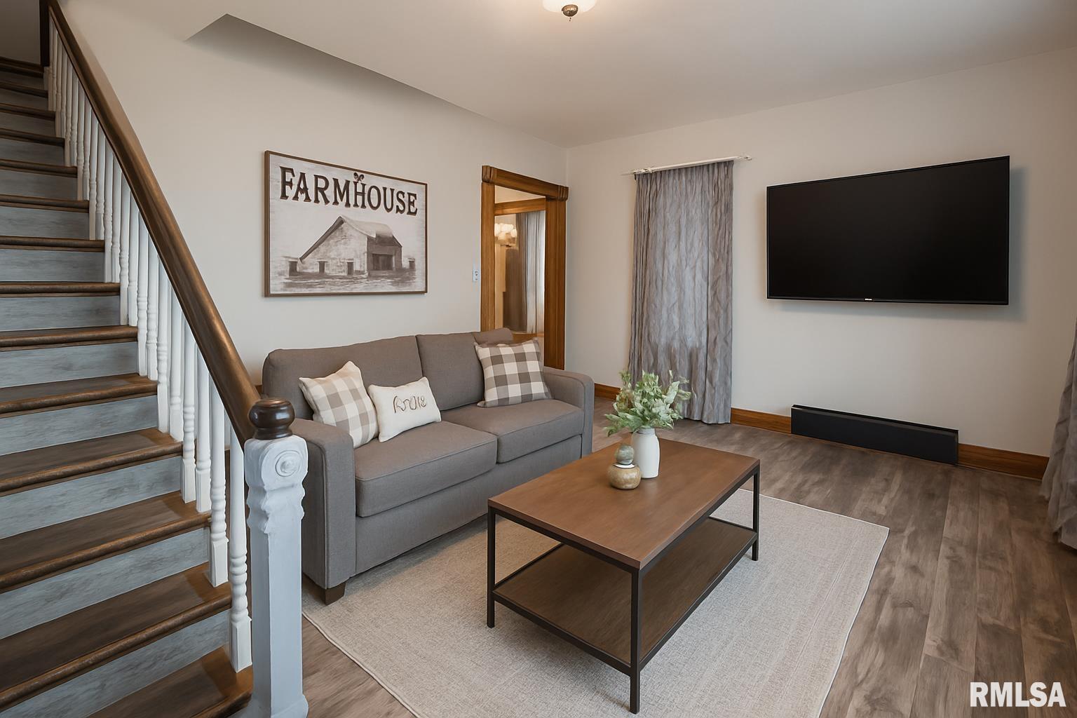 201 North 1st Street Alpha, IL 61413 - Photo 10 of 28 a living room with furniture and a flat screen tv