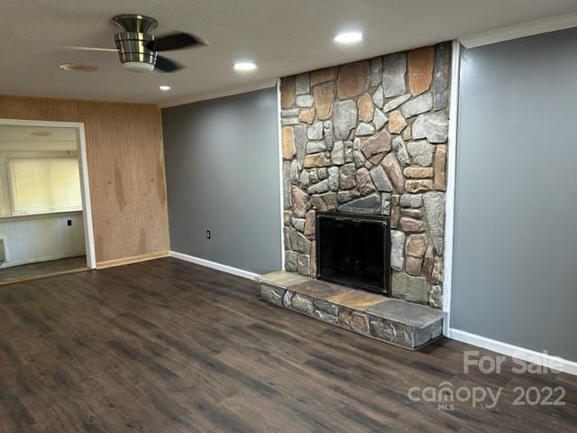 110 Joycetown Church Road Southwest Lenoir, NC 28645 - Photo 15 of 42 an empty room with wooden floor a fireplace and entryway