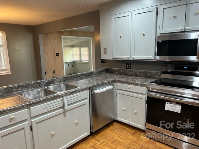 110 Joycetown Church Road Southwest Lenoir, NC 28645 - Photo 18 of 42 a kitchen with granite countertop a sink stove and cabinets