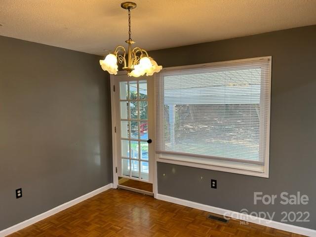 110 Joycetown Church Road Southwest Lenoir, NC 28645 - Photo 20 of 42 a view of a livingroom with a chandelier and wooden floor