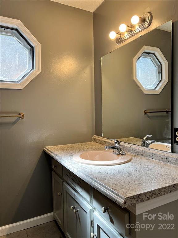 110 Joycetown Church Road Southwest Lenoir, NC 28645 - Photo 27 of 42 a bathroom with a granite countertop sink a mirror and vanity