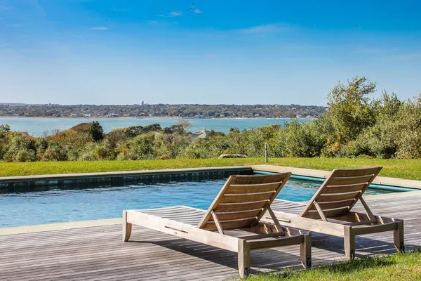 a view of a terrace with wooden floor and a lake view