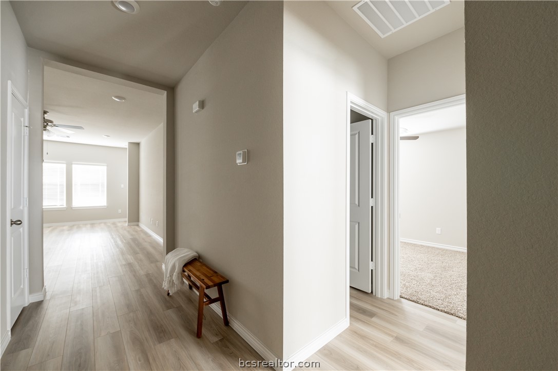 2159 Chief Street Bryan, TX 77807 - Photo 2 of 22 a view of a hallway with wooden floor and a bathroom