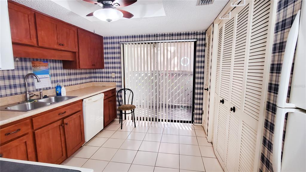 603 Baldwin Avenue, Unit B Safety Harbor, FL 34695 - Photo 13 of 32 a kitchen with a sink a stove cabinets and a window