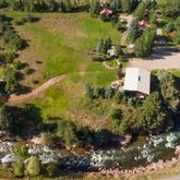a view of a chairs and table in the backyard