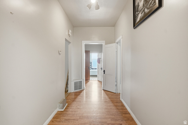 5264 West 5500th Street South Hooper, UT 84315 - Photo 14 of 38 Hallway featuring wood-finish flooring, light neutral wall paint, and white trim