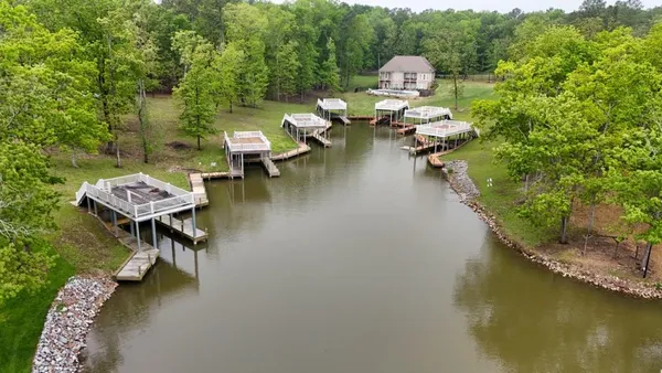 an aerial view of a house with swimming pool patio and outdoor seating